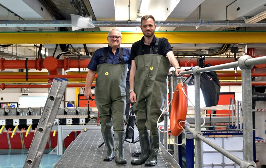 David De Ruyter and colleague standing at the side of the wave tank