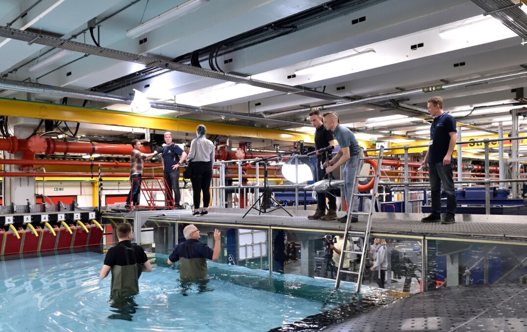 Film crew and Imperial team around the tank with two Imperial colleagues in the water